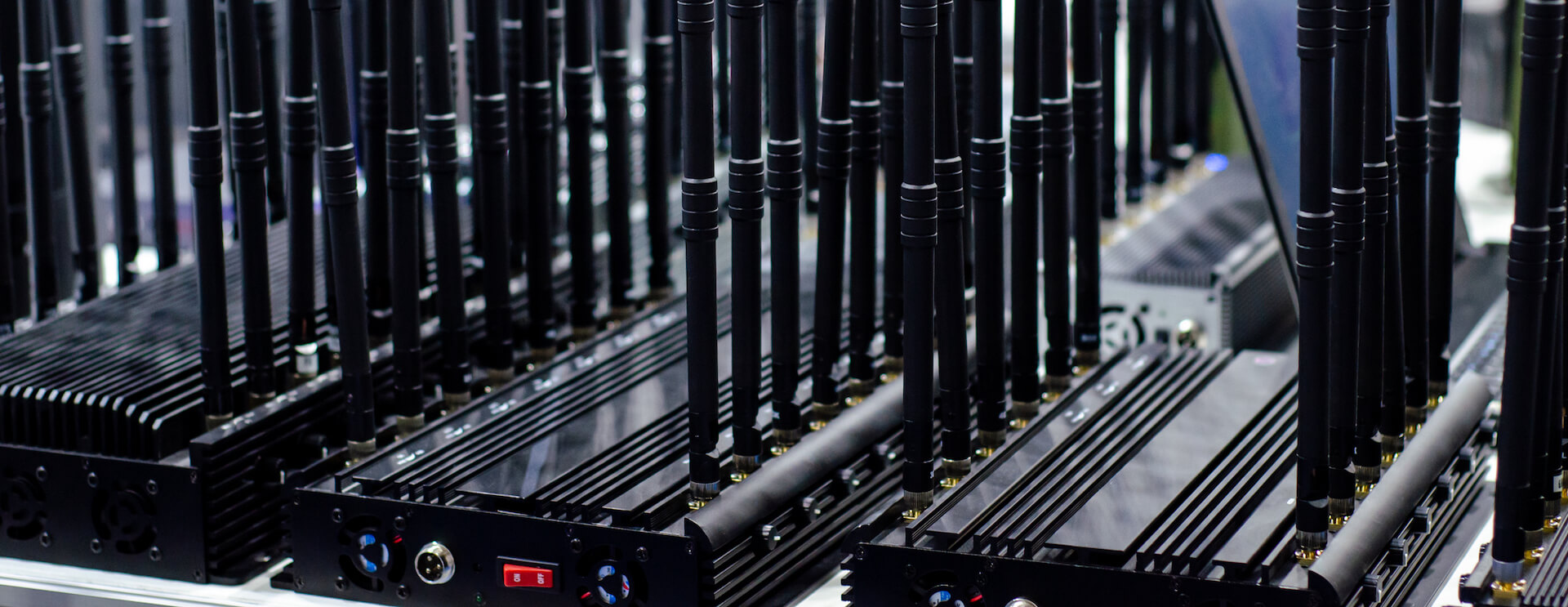 Multiple WiFi jammer devices sitting on a table.